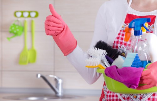 Technician handling cleaning products carefully during carpet cleaning